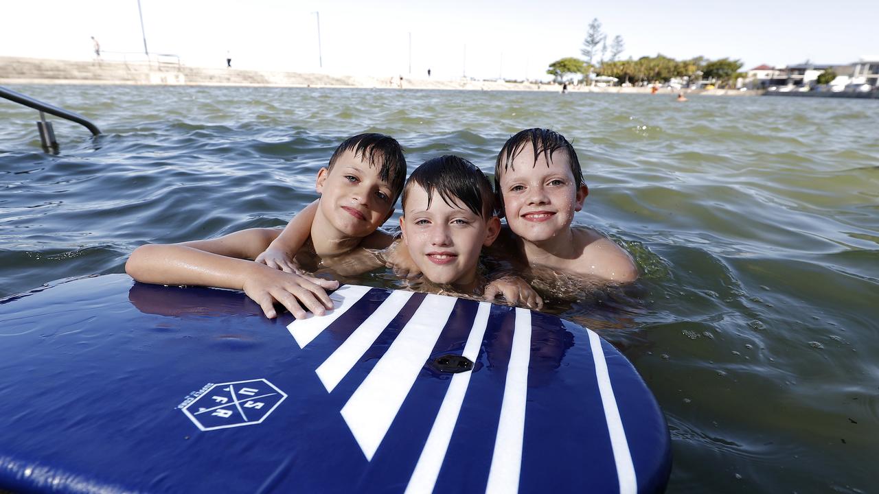 Azayah Palmer, 9, Alijah Palmer, 8, and Jayden Palmer, 10, pictured at the Wynnum wading pool. (Image/Josh Woning)