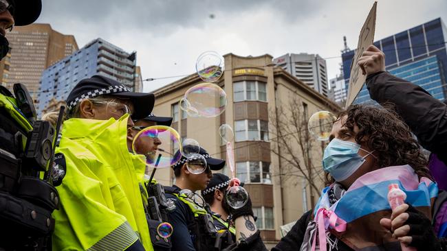 A protester blows bubbles in front of police during a counter-protest by the Transgender Liberation group against an anti-trans event in Melbourne. Picture: NewsWire/Tamati Smith