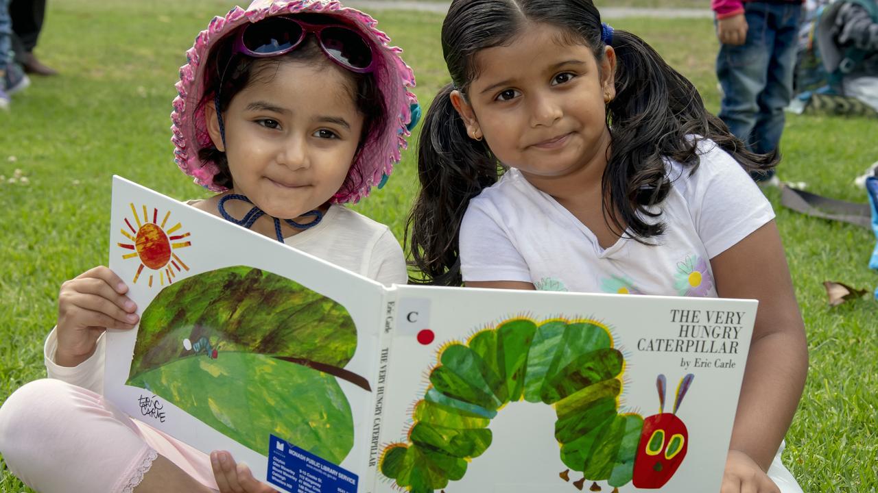 Somya and Sijal during story time at the library at Oakleigh, Victoria. The Very Hungry Caterpillar is one of the most read library books around the world. Picture: Andy Brownbill