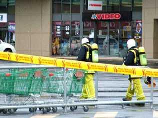 On the job: Firemen with breathing apparatus tackle the fire at Ballina Fair shopping centre yesterday. Picture: Rebecca Lollback