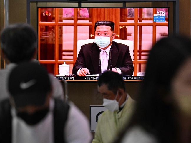 North Korea’s leader Kim Jong-un appearing in a face mask on television for the first time to order nationwide lockdowns after the North confirmed its first-ever Covid-19 cases. Picture: AFP