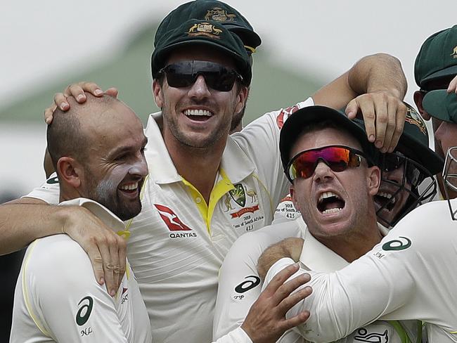 Australia's bowler Nathan Lyon, left, and teammates celebrate after running out South Africa's batsman AB de Villiers, far right, for a duck on day four of the first cricket test match between South Africa and Australia at Kingsmead stadium in Durban, South Africa, Sunday, March 4, 2018. (AP Photo/Themba Hadebe)