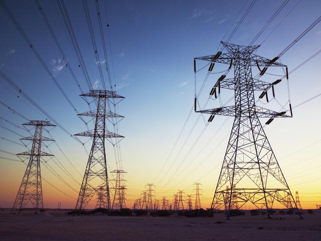 Power cables going in to the distance at dusk.