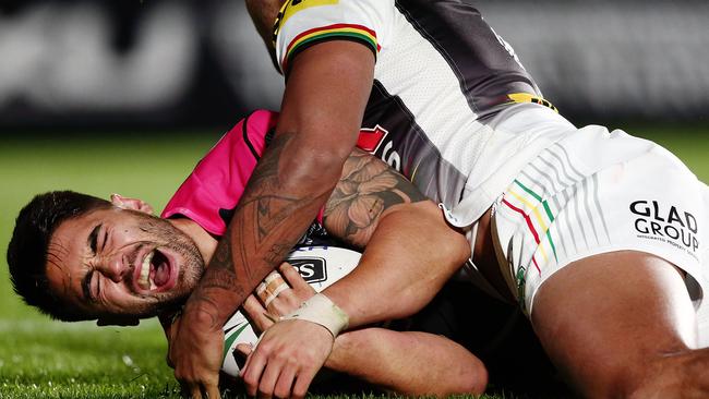 Shaun Johnson of the Warriors shows sign of pain after being tackled by Waqa Blake.