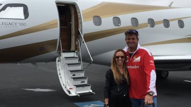 Scott and Lisa Hookey with a private jet.