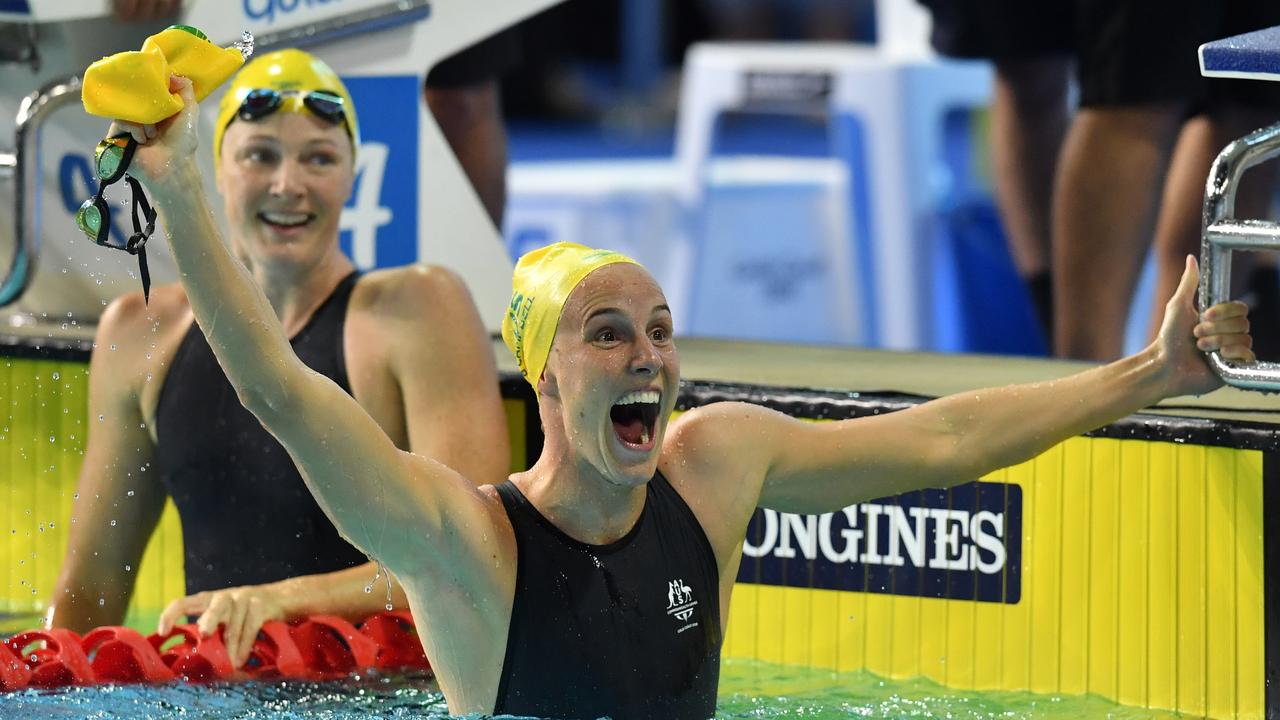 Bronte Campbell celebrates her win in the 100m freestyle as Cate looks on. (AAP Image/Darren England)