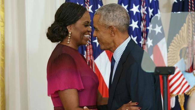 Former US president Barack Obama and wife Michelle Obama embrace during the unveiling of the Obamas' official White House portraits in the East Room of the White House. Picture: AFP.