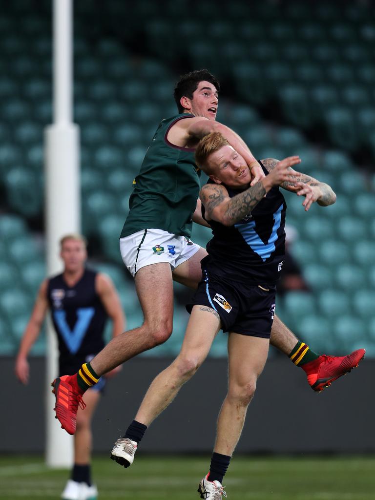 Vic Metro JhyE Baddeley- Kelly and Tasmania Harrison Gunther contest a mark at UTAS Stadium. PICTURE CHRIS KIDD