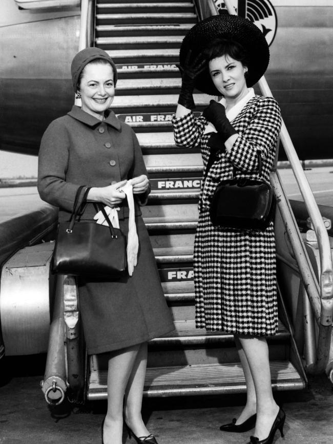 US actress Olivia de Havilland (L) and Italian actress Gina Lollobrigida pose at a Parisian airport in 1963.