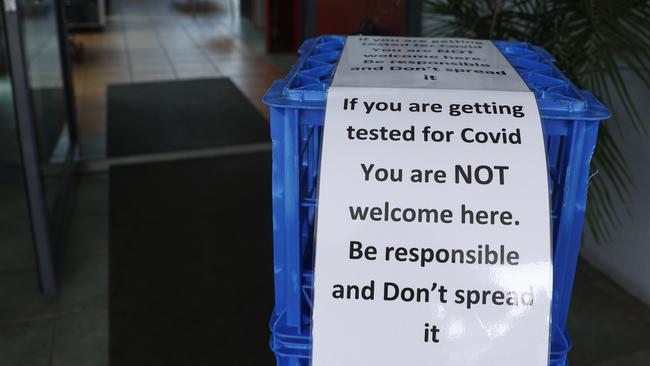 Signs at Zac's Bistro at Murrarie to deter people lining up for Covid testing to enter the cafe. Picture: Lachie Millard