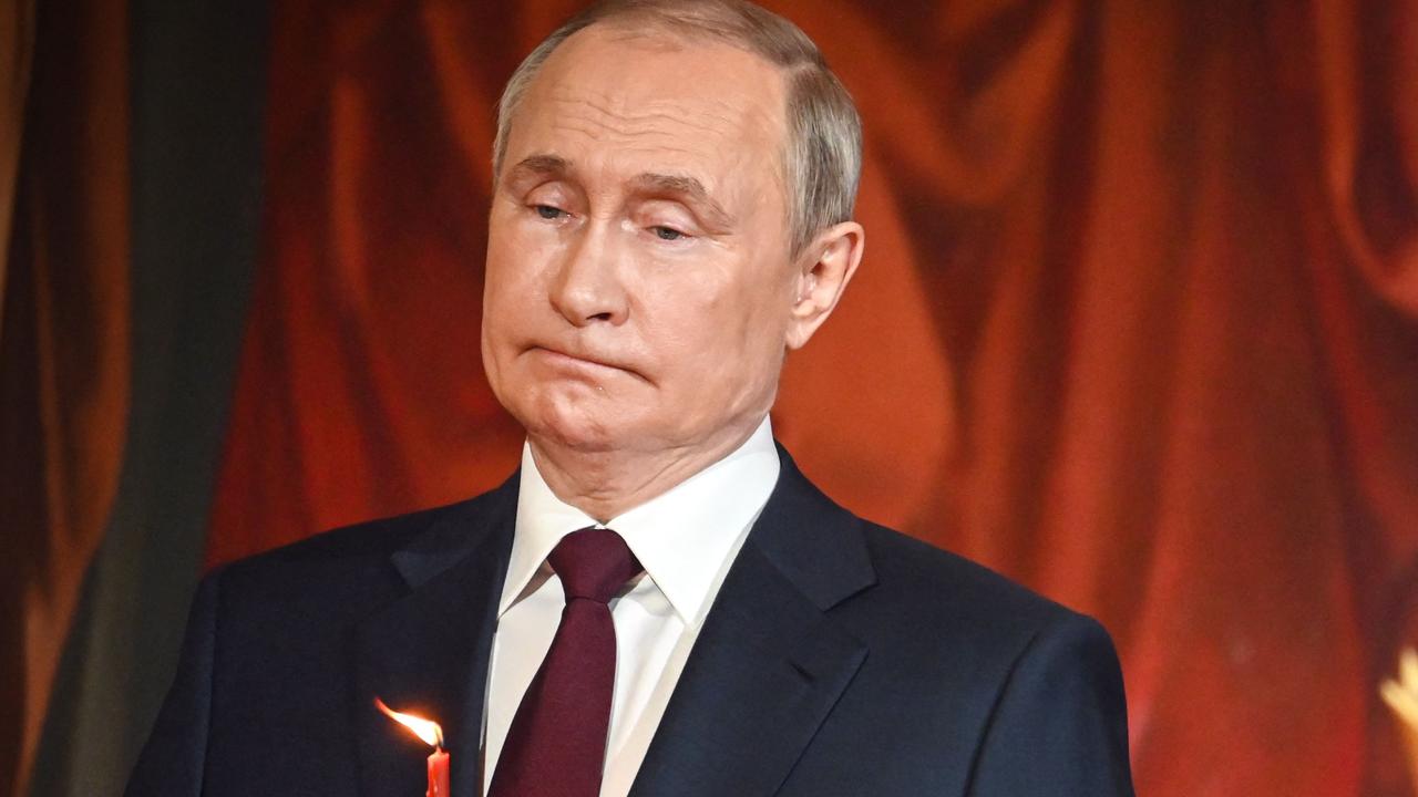 Vladimir Putin was seen biting his lips at midnight mass in Moscow. Picture: AFP