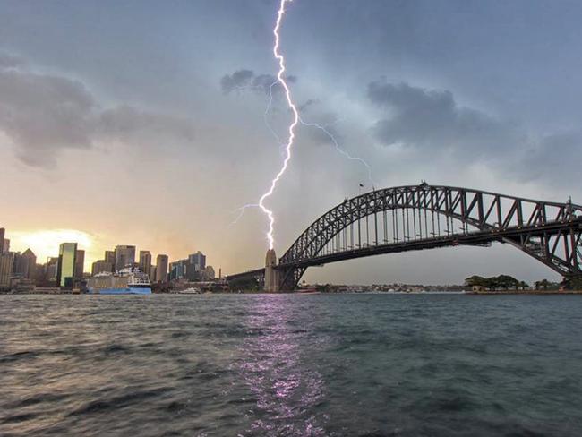 A bolt appears to strike one of the Harbour Bridge’s pylons. Picture: Matt Lynch / Instagram