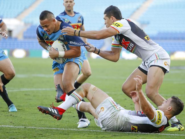 Phillip Sami of the Titans (right) is tackled during the Round 22 NRL match between the Gold Coast Titans and the Penrith Panthers at Cbus Super Stadium on the Gold Coast, Saturday, August 11, 2018. Picture: AAP Image/Glenn Hunt