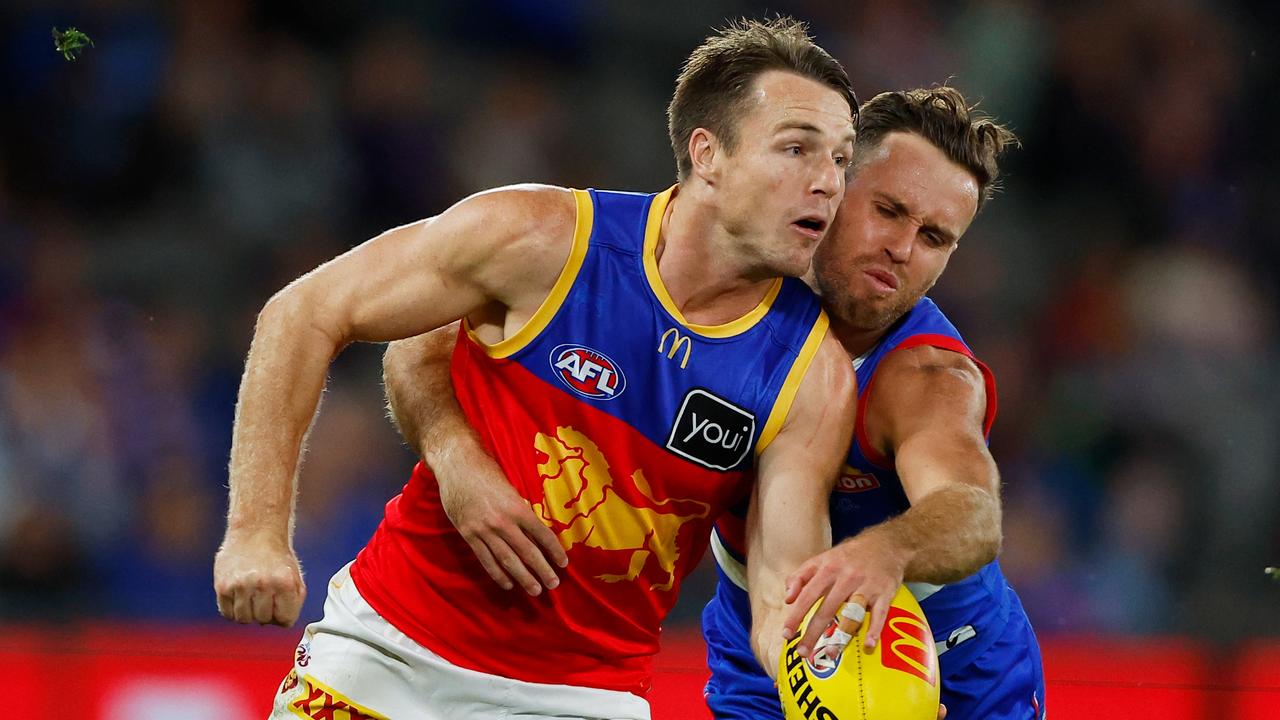 MELBOURNE, AUSTRALIA – MARCH 30: Lincoln McCarthy of the Lions is tackled by Hayden Crozier of the Bulldogs during the 2023 AFL Round 03 match between the Western Bulldogs and the Brisbane Lions at Marvel Stadium on March 30, 2023 in Melbourne, Australia. (Photo by Dylan Burns/AFL Photos via Getty Images)