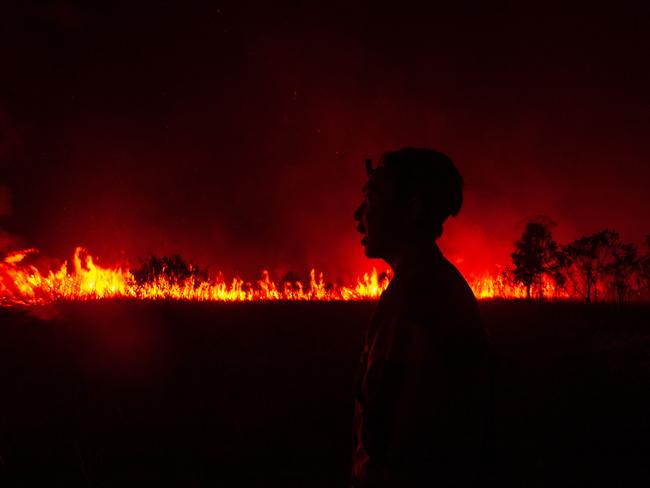 A firefighter reacts as they attempt to extinguish a wildfire in Ogan Ilir, South Sumatra. Hundreds of hectares of land have burned over the past two days, worsening the air quality in the city of Palembang. Picture: Ai Zulkifli/AFP 