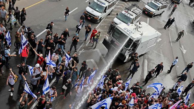 Israeli police turn water cannon on protesters in Tel Aviv on Thursday. Picture: AFP