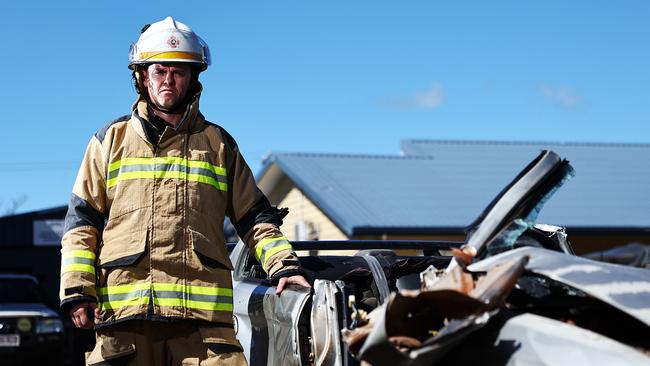 Queensland Fire Department's Tarrant Green with a wrecked vehicle used to train in firefighters in the use of pneumatic cutting tools, including the jaws of life. Picture: Brendan Radke