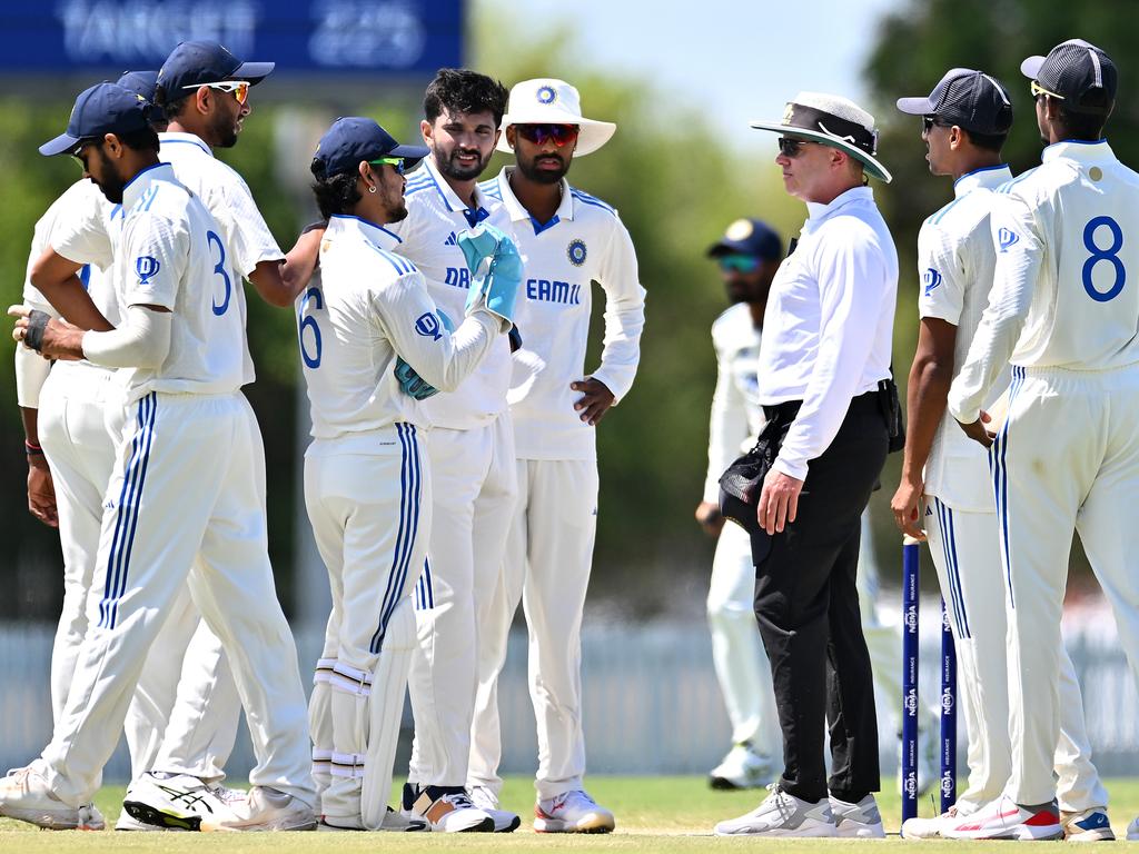 Ishan Kishan of India A is spoken to by match umpire Shawn Craig. Picture: Getty