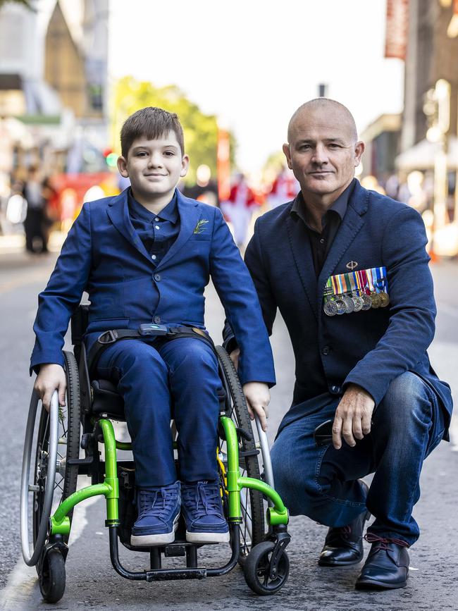 Ric Todd with his son Mitchel, 11, preparing for the ANZAC Day parade through Brisbane city. Picture Matthew Poon