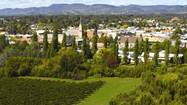 Aerial view of the town of Mudgee, NSW, with wine vineyards in foreground.