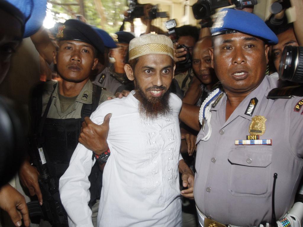 Umar Patek escorted by anti-terror police as he arrives at Bali Police Headquarters in Denpasar, Bali, Indonesia, in 2011.