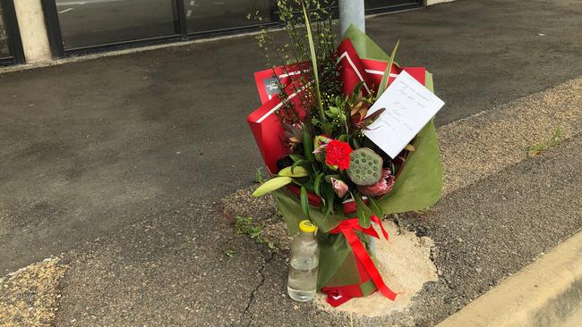 Flowers left where a man died on Flinders St, Townsville.