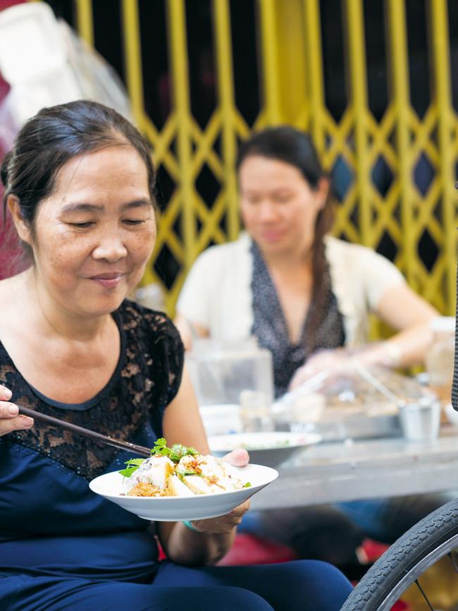 A Saigon woman samples hand-made rice noodles. Picture: Alan Benson