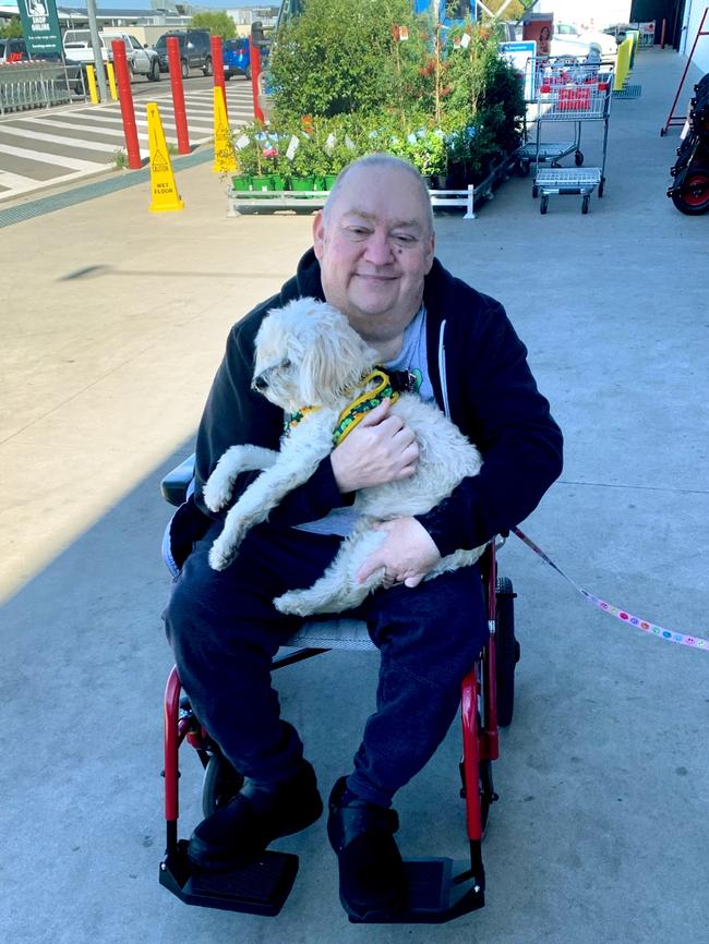 Mr Wilson with one of the dogs he loved meeting at his local Bunnings.