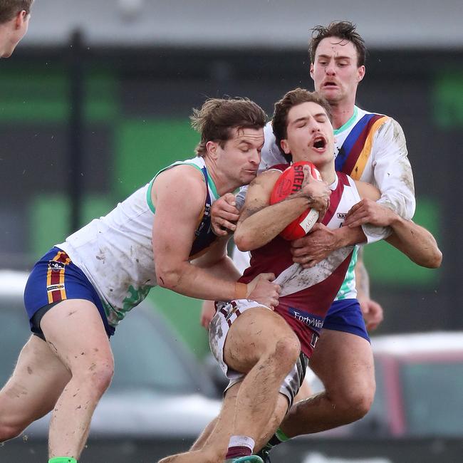 Moe’s Ben Daniher and Ben Maslen outnumber Traralgon’s Luis D'Angelo.