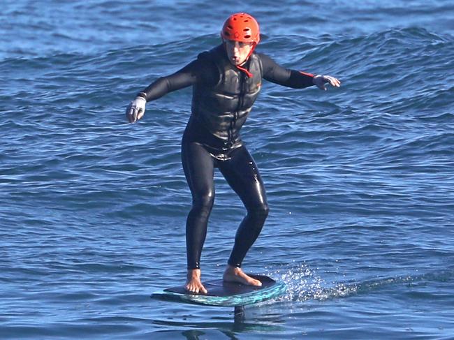 *PREMIUM EXCLUSIVE* Mark Zuckerberg flaps his arms as he Hydrofoils in Hawaii. The 36-year-old Facebook founder and billionaire has been seen a number of times on his $12,000 Efoil board, which allows users to glide above the water. This is the first time he's been seen wearing a helmet - so it appears he's improving and going faster. He has also toned down the amount of sunscreen he wears on his face after pictures of him with a white 'clown' face went viral. Zuckerberg and wife Priscilla own an enormous amount of land on Hawaii. He reportedly paid $100 million for multiple properties along the North Shore of Kaua'i back in 2014, and another $45 million for additional property in 2017. 06 Dec 2020 Pictured: Mark Zuckerberg. Photo credit: MEGA TheMegaAgency.com +1 888 505 6342 (Mega Agency TagID: MEGA719633_014.jpg) [Photo via Mega Agency]