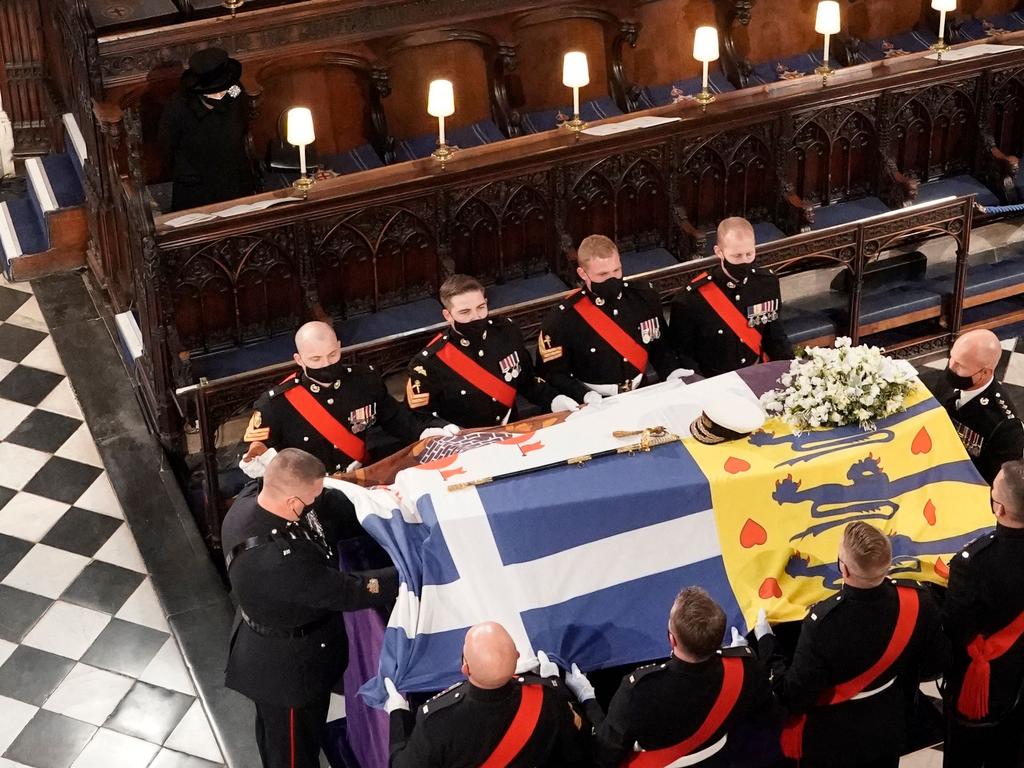 Prince Philip’s naval sword and cap were on the English Oak coffin that was draped in his personal standard. Picture: AFP