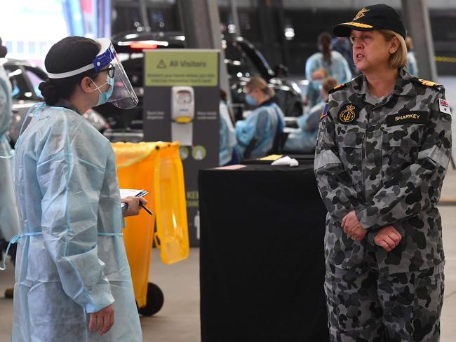 Surgeon General of the ADF, Rear Admiral Sarah Sharkey speaks to defence personnel manning a drive-through testing station in Melbourne. Picture: AFP