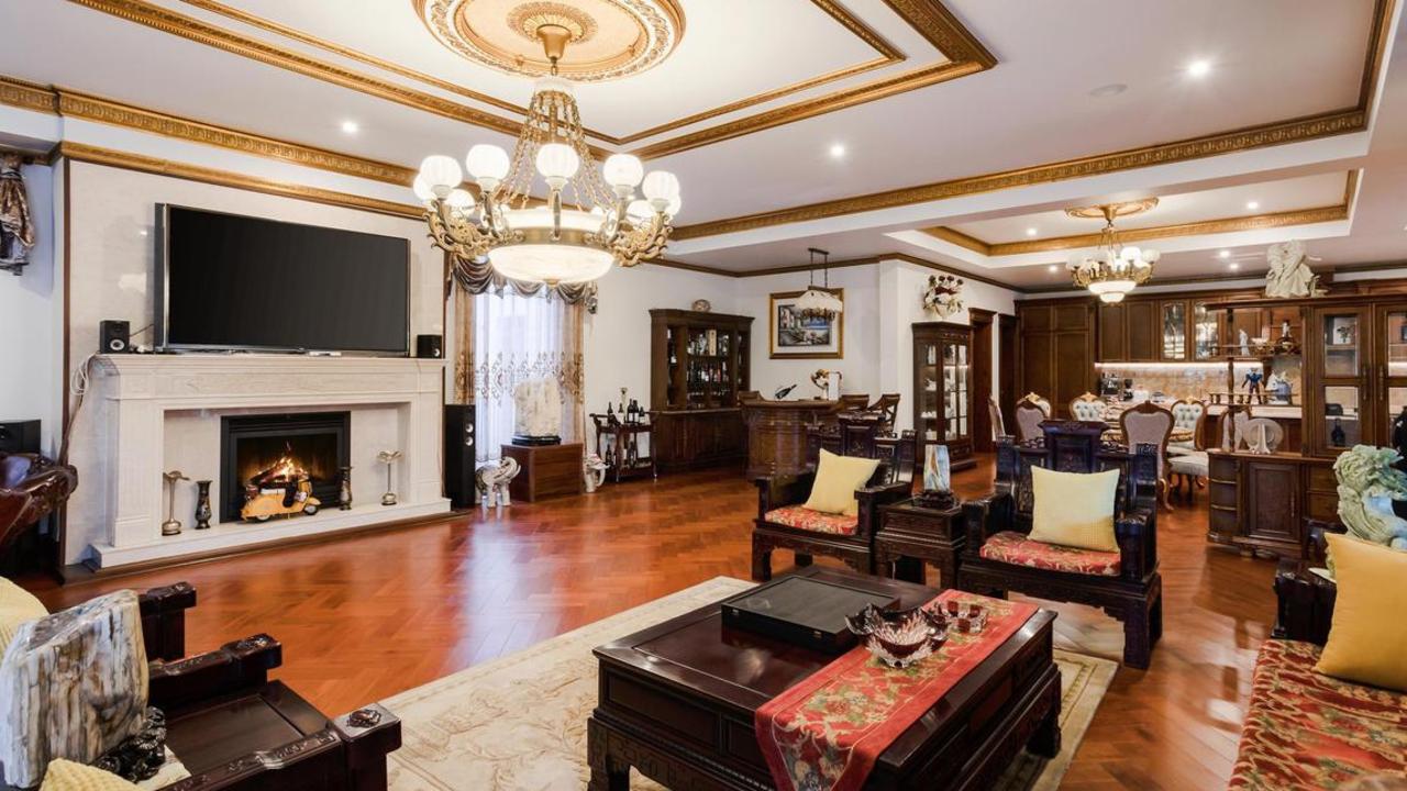 A fireplace, parquetry floors and chandeliers make an elegant statement.