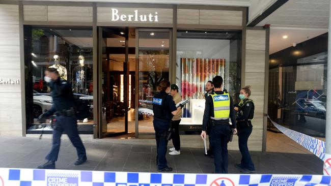 Police investigate an overnight break-in and theft from the luxury Collins Street clothing store Berluti. Picture: Andrew Henshaw