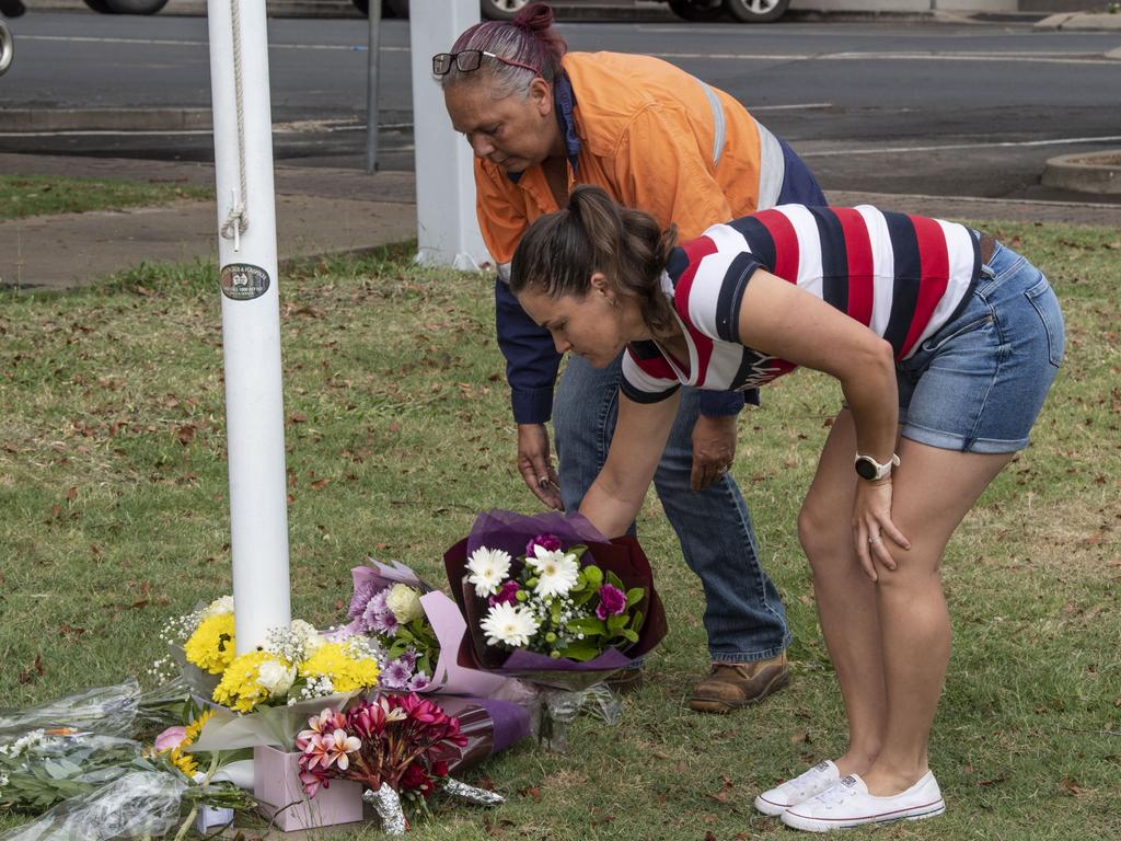 Leah Bulger (left) and Annie Grewar lay flowers at Chinchilla Police Station in memory of fallen officers. Tuesday, December 13, 2022. Picture: Nev Madsen.