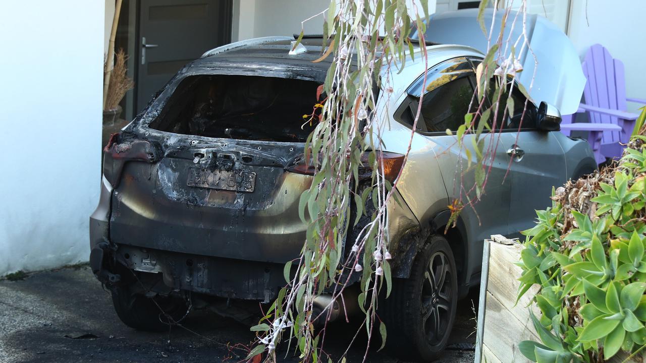 A car destroyed by fire in the driveway of a Jan Juc house in Marner Close. Picture: Alison Wynd