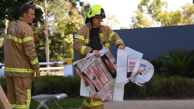 A fire fighter is seen carrying a hazardous material bag into the Korean consulate in Melbourne, Wednesday, January 9, 2018. Staff have been evacuated as emergency crews respond to a number of incidents involving foreign consulates in Melbourne.  (AAP Image/James Ross) NO ARCHIVING