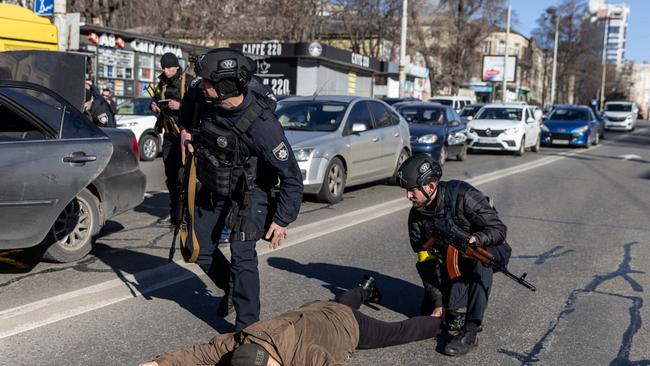 Police officers search a man at a checkpoint in Kyiv, Ukraine. Picture: Getty Images