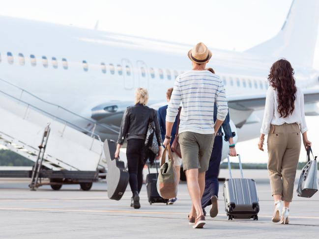Back view of passengers boarding on the plane. Outdoor shot.Photo - istockESCAPE6 MARCH 2022 COVER FEATURE DOC HOLIDAY FLYING TRAVEL