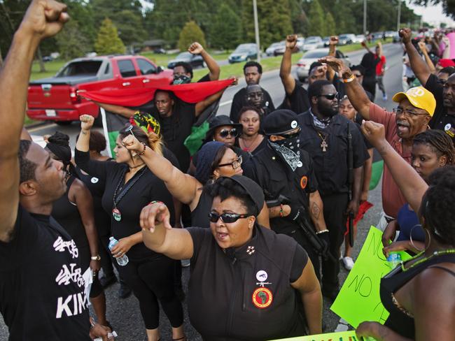 Members of the New Black Panther Party march in front of the Baton Rouge Police Department headquarters on Saturday. Picture: Max Becherer