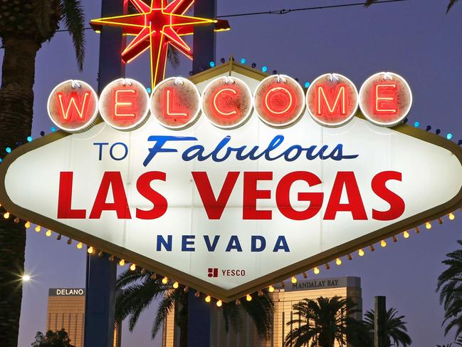 LAS VEGAS, NEVADA - FEBRUARY 28: Blue and yellow lights flicker around the border of the Welcome to Fabulous Las Vegas sign on the Las Vegas Strip as a show of support for Ukraine on February 28, 2022 in Las Vegas, Nevada. Clark County (NV) changed the colored bulbs on top, which are usually all yellow, to blue to match the flag of Ukraine, as people across the globe react to Russia's invasion of the country.   Ethan Miller/Getty Images/AFP == FOR NEWSPAPERS, INTERNET, TELCOS & TELEVISION USE ONLY ==