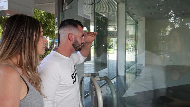 The Cairns Regional Council is looking at ways to convert empty commercial retail space in the city centre into residential zones. Bonnie Campbell and Zak Castini from Brinsmead look into an empty shop on Shields Street. Picture: Brendan Radke