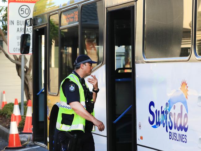 Queensland Police board and stop and question a bus passenger on a Government Bus at the QLD / NSW border check point into Queensland on Griffith Street Coolangatta. Photo: Scott Powick Newscorp