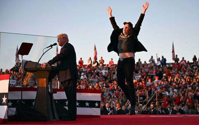 Tesla and SpaceX CEO Elon Musk exults during a Donald Trump rally in Pennsylvania in October 2024 -- the pair have become fast friends