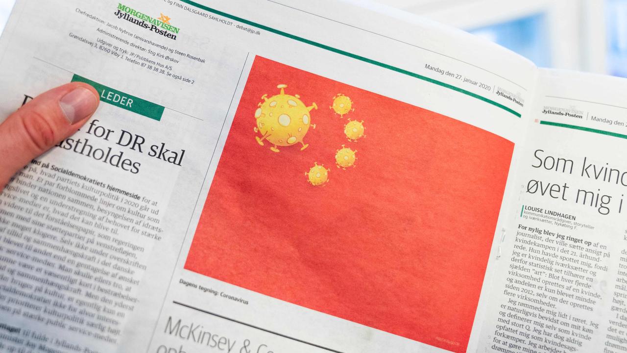 A page of the Danish Daily Newspaper Jyllands-Posten's from the January 27, 2020 edition shows a cartoon made by Danish editorial cartoonist Niels Bo Bojesen of the Chinese national flag with a coronavirus on January 28, 2020 in Copenhagen. (Photo by Ida Marie Odgaard / Ritzau Scanpix / AFP)