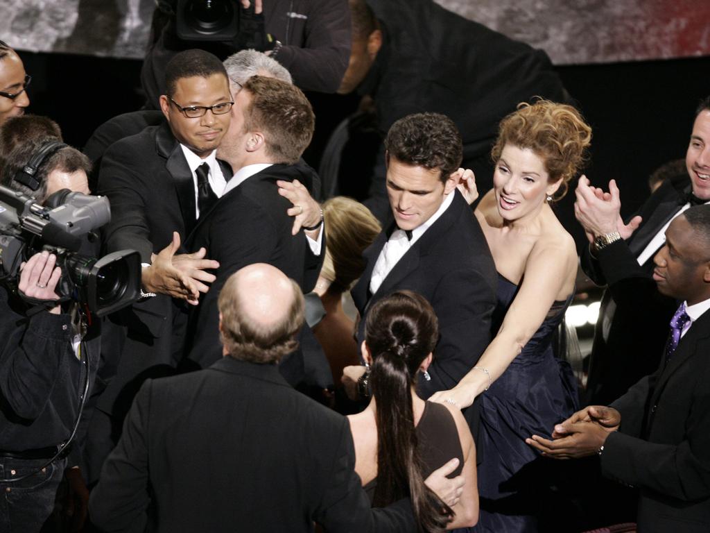 The cast of <i>Crash</i>, including Matt Dillon (centre) and Sandra Bullock (bottom front) flock towards the staged after the film won best picture Oscar in 2006.