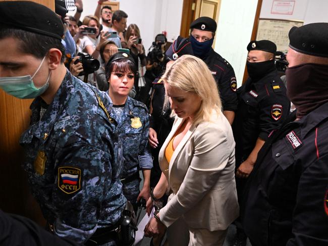 Marina Ovsyannikova escorted by police before a court session over charges of “discrediting” the Russian army. Picture: AFP