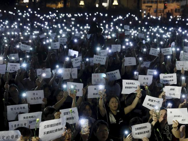 Hundreds of mothers holding placards, some of which read ‘If we lose the young generation, what's left of Hong Kong’, and lit smartphones protest against the amendments to the extradition law in Hong Kong. Picture: AP