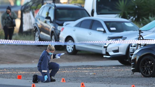 Forensic police collect evidence at the scene of a fatal shooting in Ravenhall. Picture: David Crosling