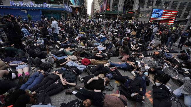 Protesters lay on the ground with their hands behind their back during a Black Lives Matter protest. Picture: AFP